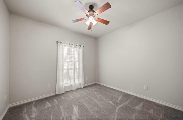 carpeted spare room featuring ceiling fan