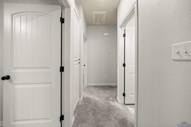 hallway with light colored carpet