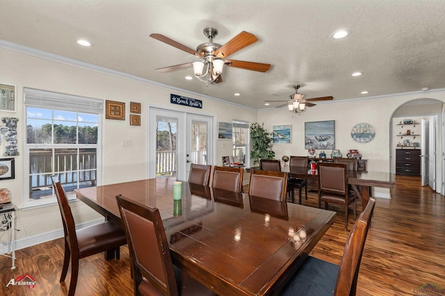 dining room featuring dark hardwood / wood-style flooring, ceiling fan, crown molding, a textured ceiling, and french doors