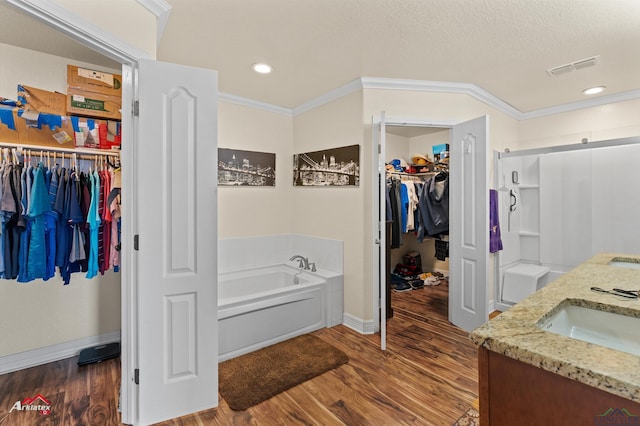 bathroom with crown molding, separate shower and tub, a textured ceiling, vanity, and hardwood / wood-style flooring