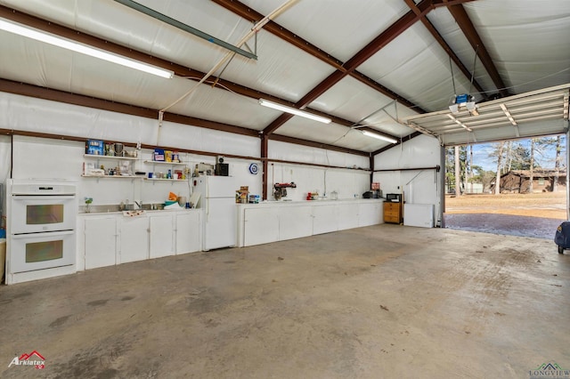 garage featuring white refrigerator and sink