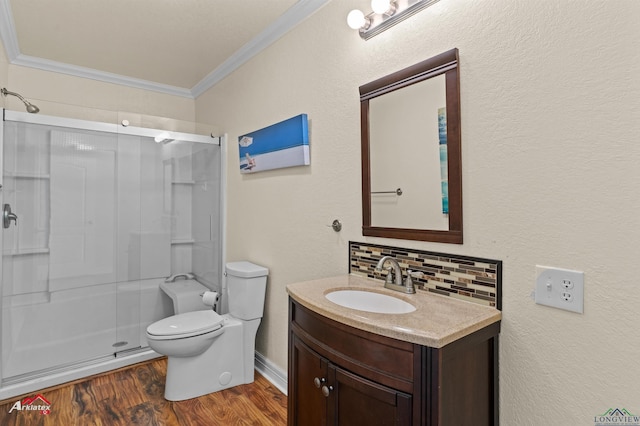 bathroom with hardwood / wood-style floors, toilet, vanity, walk in shower, and crown molding