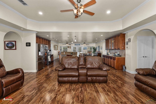 living room with ceiling fan, ornamental molding, and dark hardwood / wood-style flooring