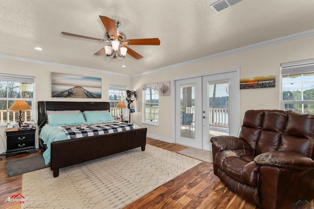 bedroom featuring hardwood / wood-style flooring, crown molding, access to exterior, and french doors