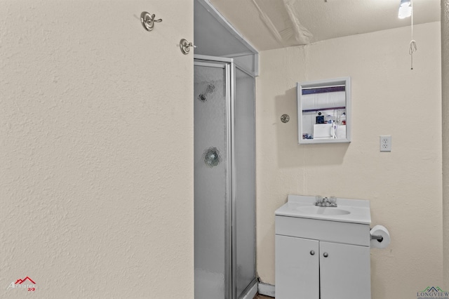 bathroom with walk in shower and vanity