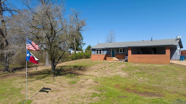 exterior space with a yard and brick siding