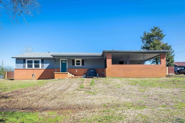 ranch-style house featuring a front yard and brick siding