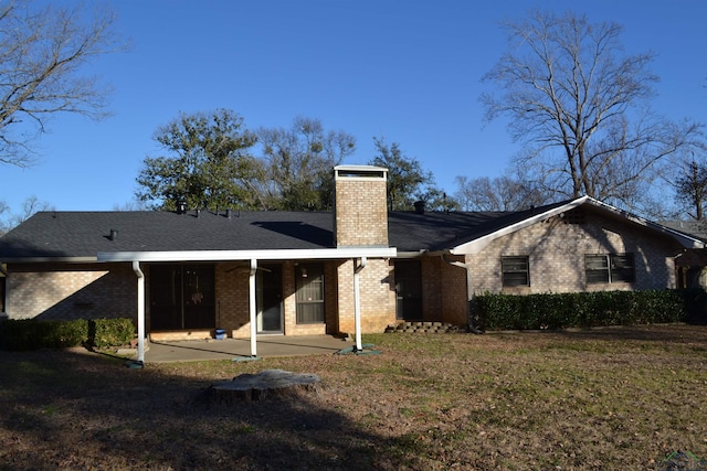 rear view of house with a yard and a patio area