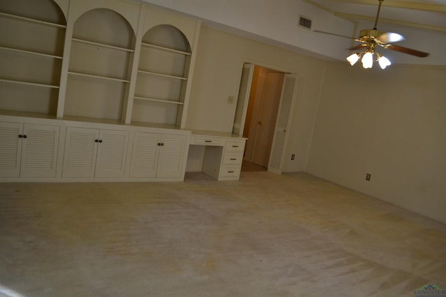 interior space featuring built in features, light colored carpet, and ceiling fan