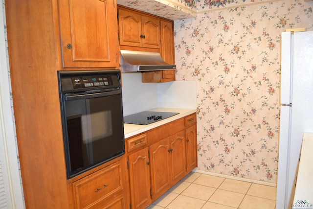 kitchen featuring ventilation hood, light tile patterned floors, and black appliances