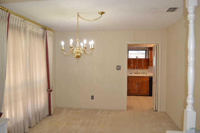 carpeted empty room featuring a chandelier, sink, and a textured ceiling