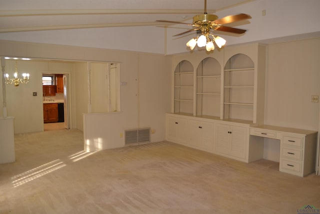 carpeted spare room with ceiling fan and built in desk