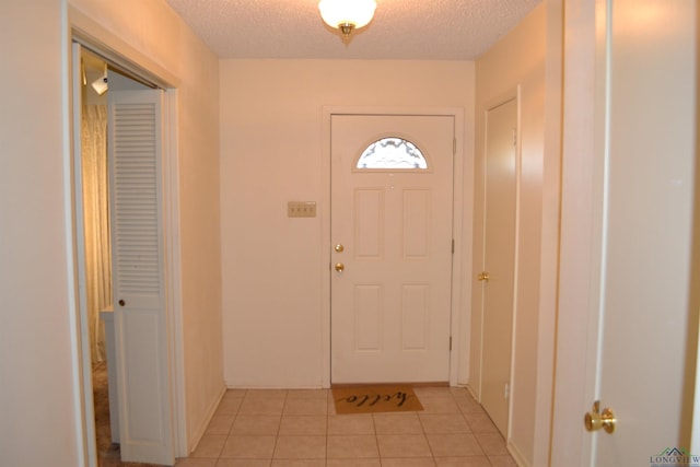 tiled entrance foyer with a textured ceiling