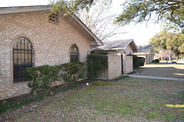 view of side of property with a yard