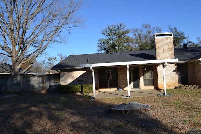 back of house with a yard and a patio