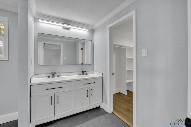 bathroom featuring tile patterned flooring, vanity, ceiling fan, and ornamental molding