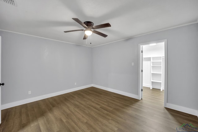 unfurnished room with dark wood-type flooring, ceiling fan, and crown molding