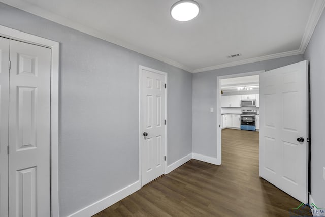 hallway with dark hardwood / wood-style flooring and ornamental molding