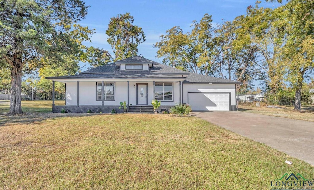 view of front of property featuring a porch, a garage, and a front lawn