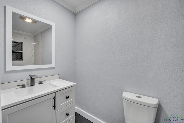 bathroom with vanity, toilet, and crown molding