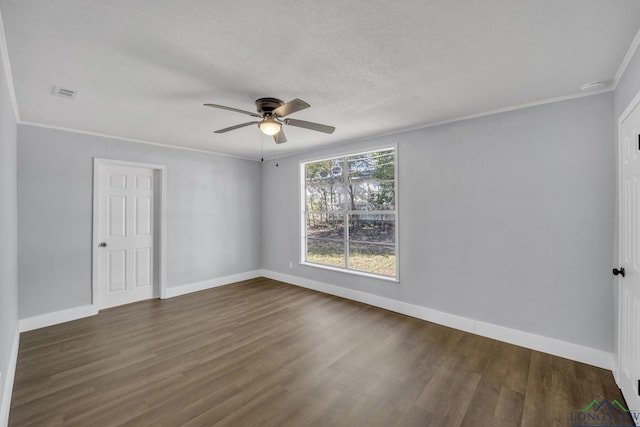 spare room featuring dark hardwood / wood-style floors, ceiling fan, and crown molding