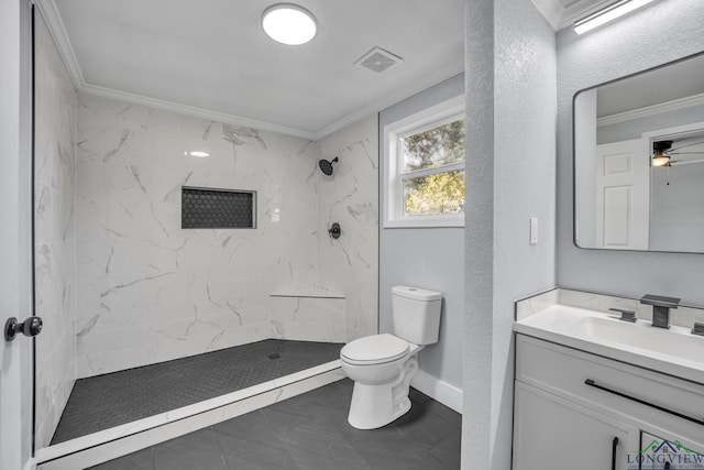 bathroom featuring vanity, toilet, crown molding, and a tile shower