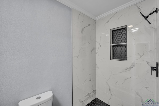 bathroom with tiled shower, toilet, and ornamental molding