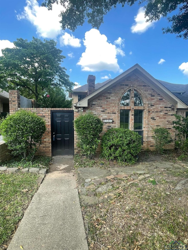 1204-1206 Brandywine, Longview, TX 75601 - view of front facade featuring brick siding, a chimney, and a gate