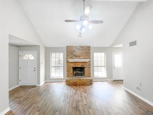 1204-1206 Brandywine, Longview, TX 75601 - unfurnished living room featuring a ceiling fan, wood finished floors, high vaulted ceiling, and a fireplace