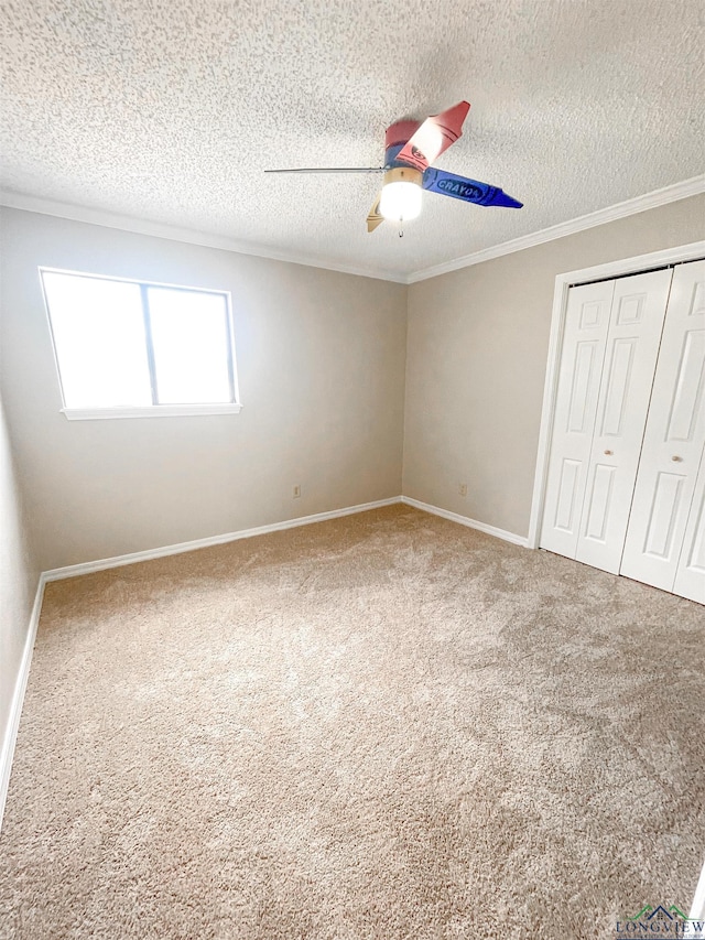 1204-1206 Brandywine, Longview, TX 75601 - unfurnished bedroom featuring a closet, carpet floors, a textured ceiling, crown molding, and a ceiling fan