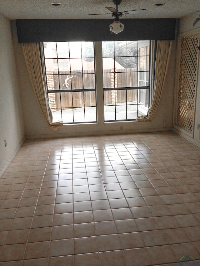 1204-1206 Brandywine, Longview, TX 75601 - unfurnished room featuring tile patterned floors, a textured ceiling, and ceiling fan
