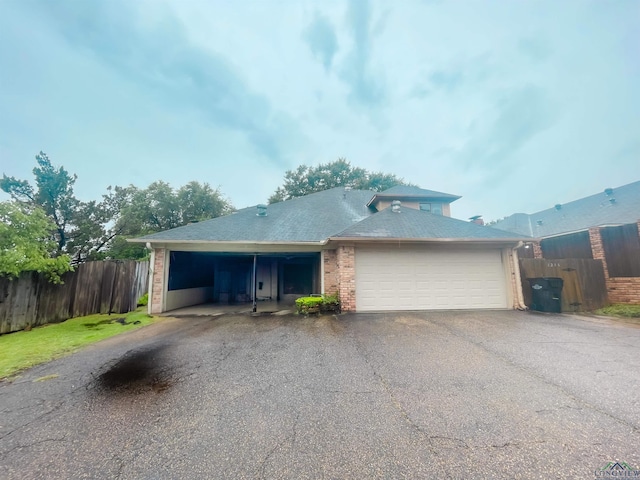 1204-1206 Brandywine, Longview, TX 75601 - view of front of property with an attached garage, asphalt driveway, and brick siding