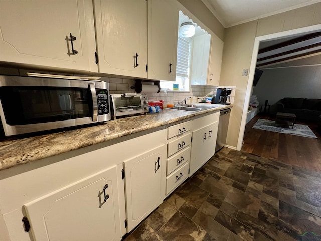 1523 Young St, Henderson, TX 75654 - kitchen featuring a sink, tasteful backsplash, stainless steel appliances, white cabinets, and a toaster