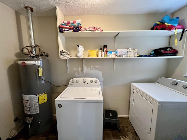 1523 Young St, Henderson, TX 75654 - laundry area with laundry area, a textured ceiling, water heater, and washing machine and clothes dryer