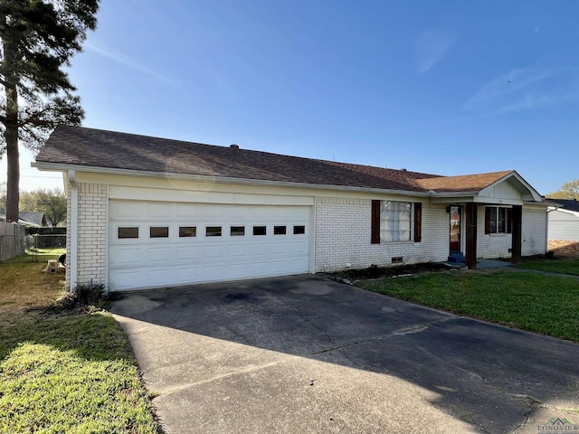 1523 Young St, Henderson, TX 75654 - ranch-style home featuring a front yard, an attached garage, brick siding, and driveway