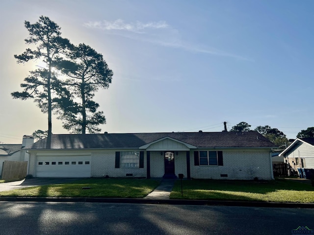 1523 Young St, Henderson, TX 75654 - ranch-style house with a front yard, fence, driveway, a garage, and brick siding