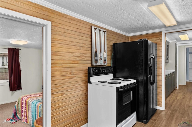 kitchen with electric range oven, hardwood / wood-style flooring, ornamental molding, and wood walls