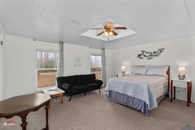 carpeted bedroom with multiple windows and ceiling fan