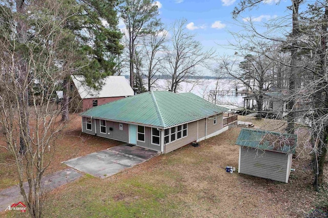 back of house featuring a water view