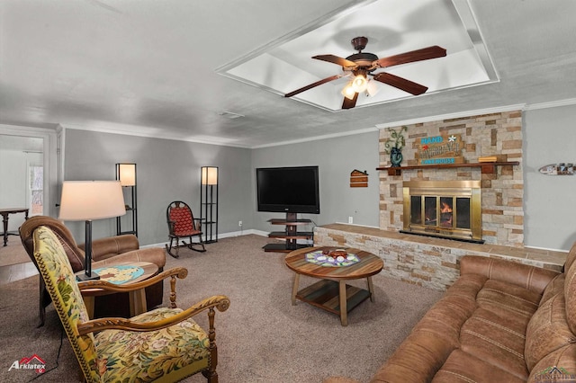 carpeted living room with a fireplace, ornamental molding, and ceiling fan