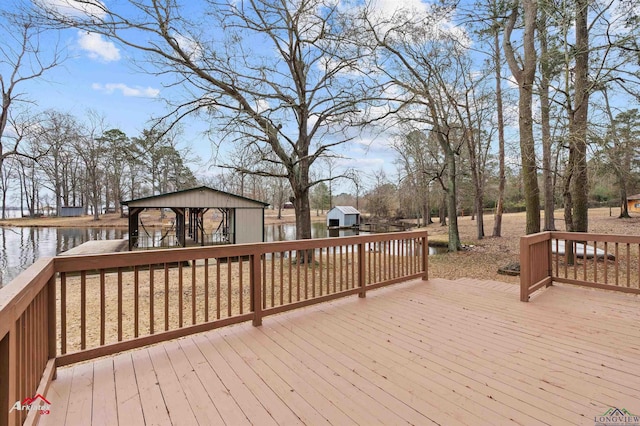 wooden deck featuring a water view and a gazebo