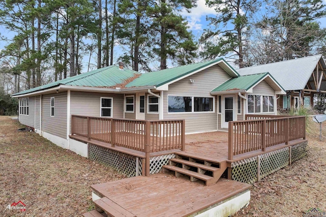 back of house with a wooden deck