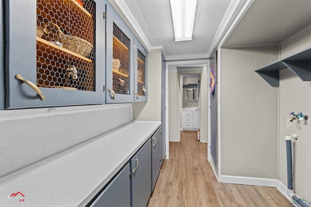 hallway with crown molding and light hardwood / wood-style flooring