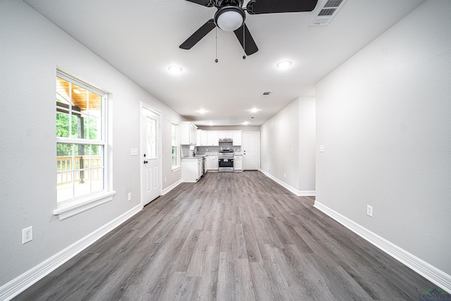 unfurnished living room with hardwood / wood-style flooring and ceiling fan