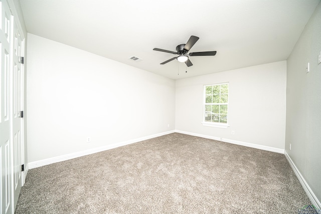 empty room with carpet and ceiling fan