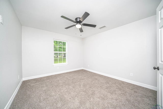 carpeted spare room featuring ceiling fan