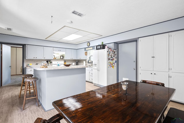 dining room with light wood-style flooring