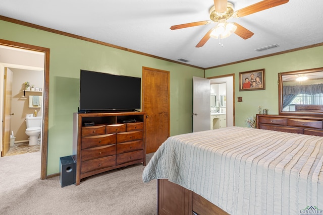 bedroom with light colored carpet, ensuite bath, ceiling fan, and crown molding