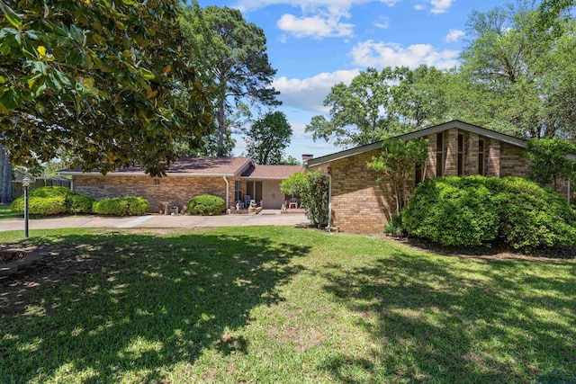 view of front of property with a front lawn and brick siding