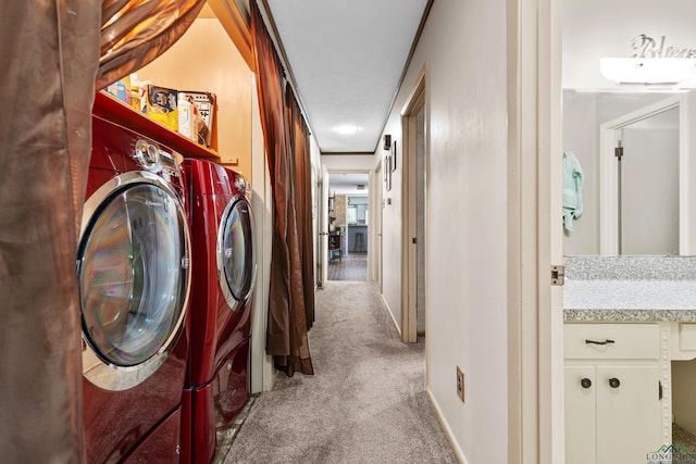 laundry area with carpet floors, washing machine and clothes dryer, and baseboards